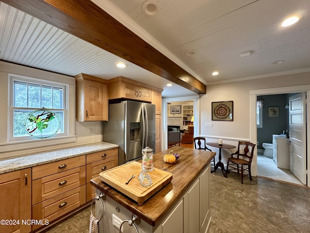 207 W Eden St, Edenton, NC 27932 - kitchen with stainless steel refrigerator with ice dispenser, crown molding, a center island, light stone counters, and recessed lighting