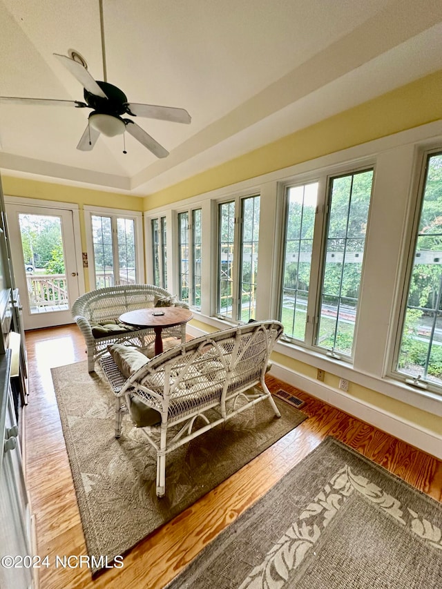 sunroom / solarium featuring ceiling fan, vaulted ceiling, and a wealth of natural light