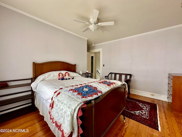 bedroom featuring ornamental molding, ceiling fan, and hardwood / wood-style flooring