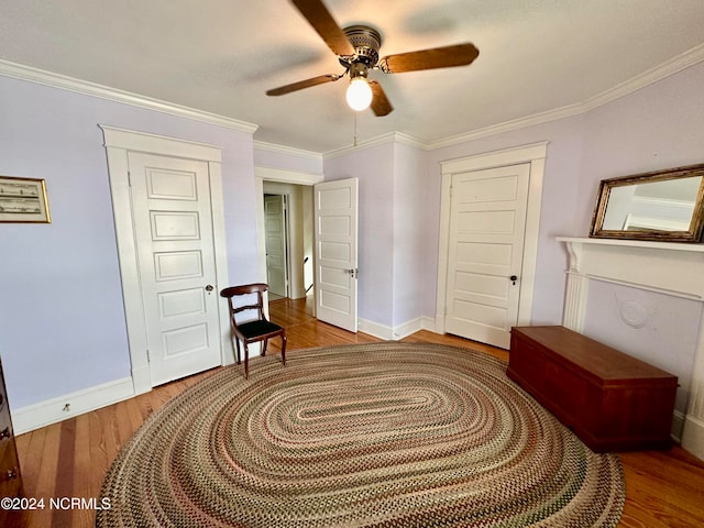 interior space with ceiling fan, hardwood / wood-style floors, and crown molding