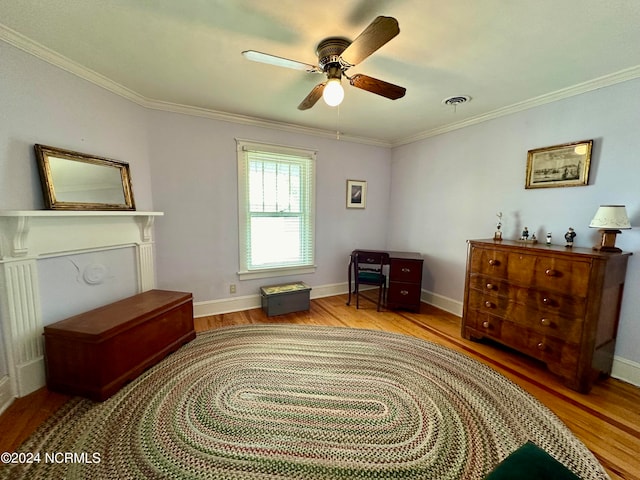 sitting room with ornamental molding, light wood-type flooring, and ceiling fan