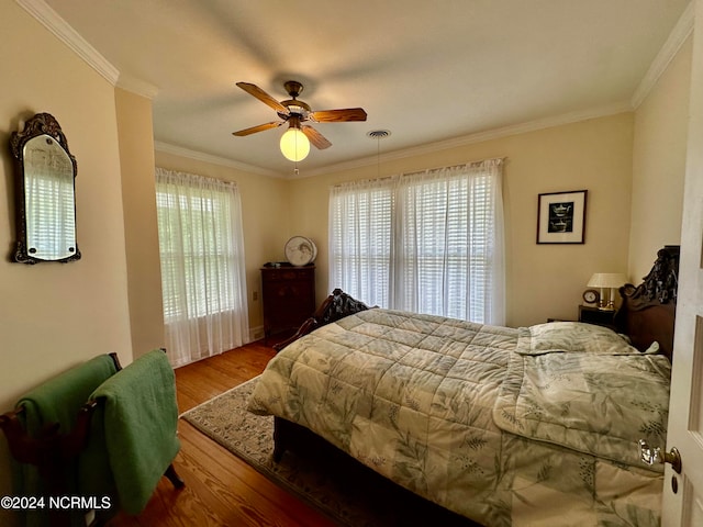 bedroom featuring ceiling fan, hardwood / wood-style floors, and ornamental molding