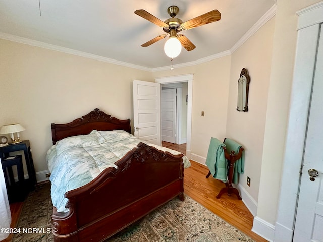 bedroom featuring ornamental molding, ceiling fan, and hardwood / wood-style floors