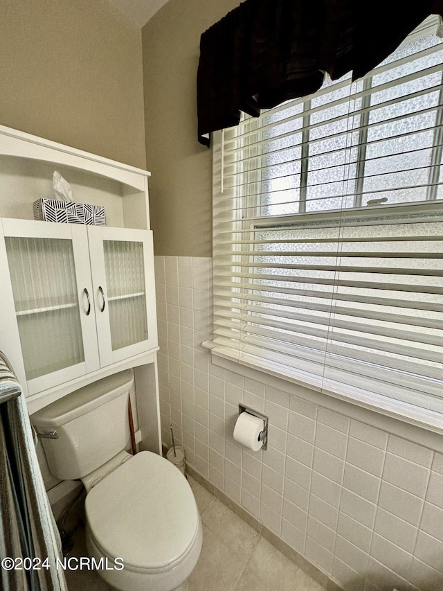 207 W Eden St, Edenton, NC 27932 - bathroom featuring tile patterned floors, tile walls, and healthy amount of natural light
