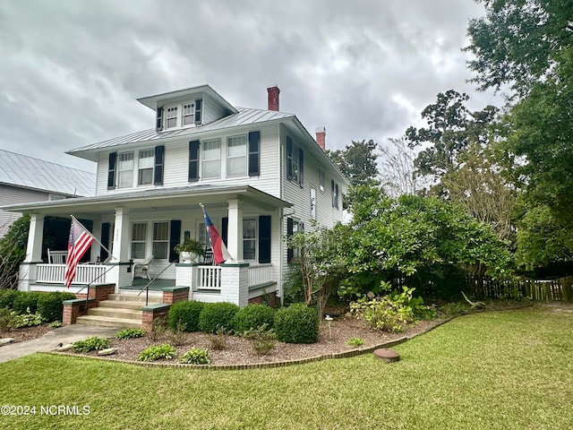 view of front facade with a front lawn and a porch