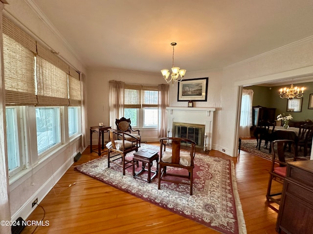 dining area with an inviting chandelier, hardwood / wood-style flooring, and crown molding