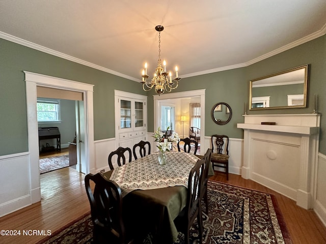207 W Eden St, Edenton, NC 27932 - dining room with a chandelier, dark wood-style flooring, ornamental molding, and wainscoting