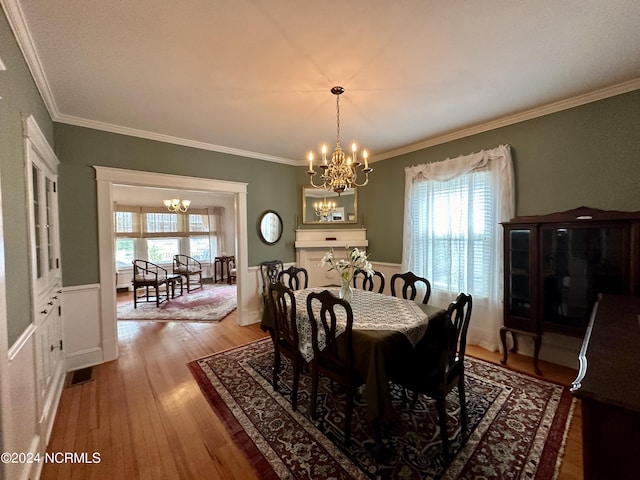 207 W Eden St, Edenton, NC 27932 - dining room featuring a chandelier, plenty of natural light, light wood-type flooring, and crown molding