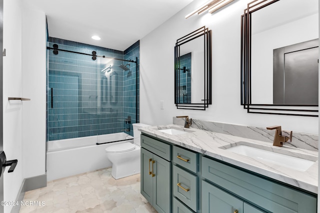 full bathroom featuring tiled shower / bath, vanity, and toilet