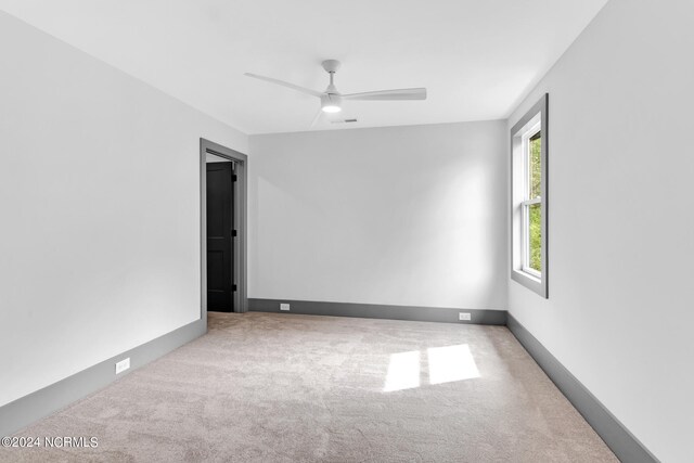 empty room featuring light carpet and ceiling fan