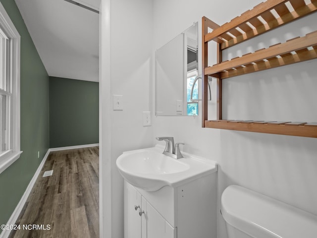 bathroom featuring hardwood / wood-style floors, vanity, and toilet