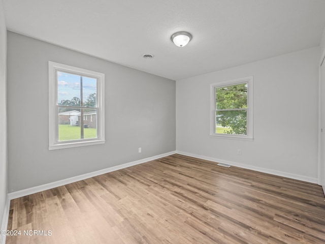 spare room with hardwood / wood-style floors