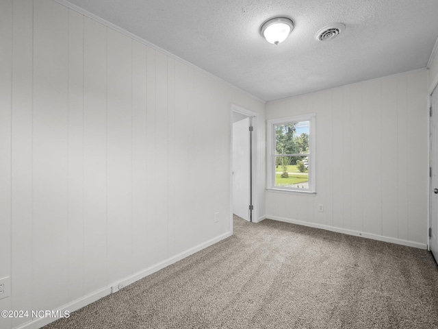 empty room featuring carpet floors and a textured ceiling