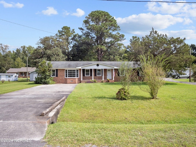 ranch-style home with a front lawn