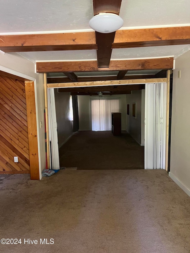 corridor with wooden walls and carpet flooring