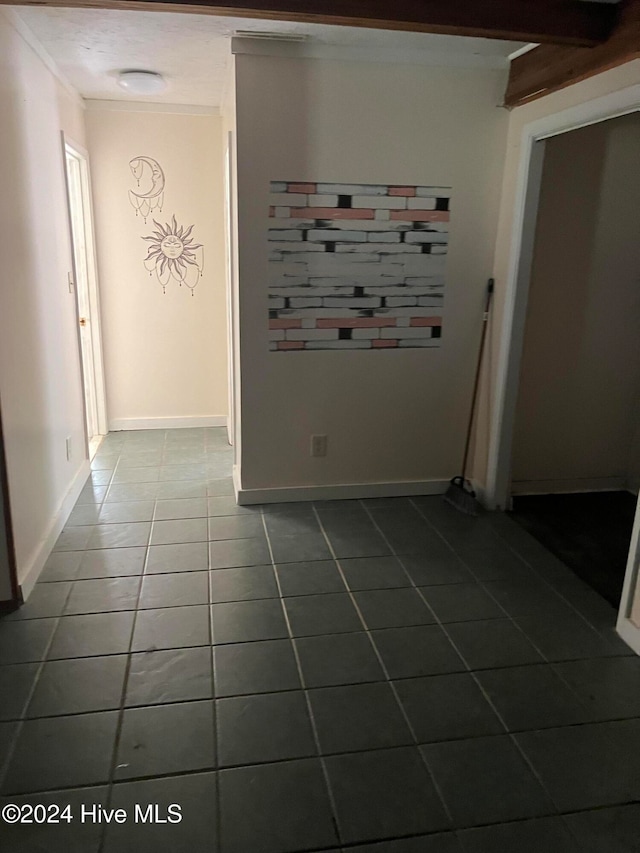 tiled empty room with crown molding