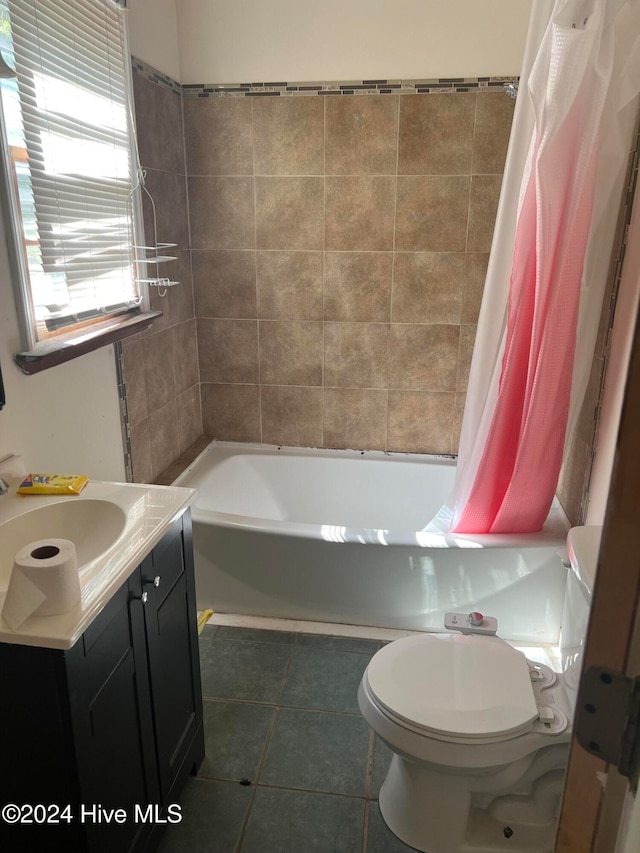 full bathroom featuring vanity, shower / tub combo with curtain, tile patterned flooring, and toilet