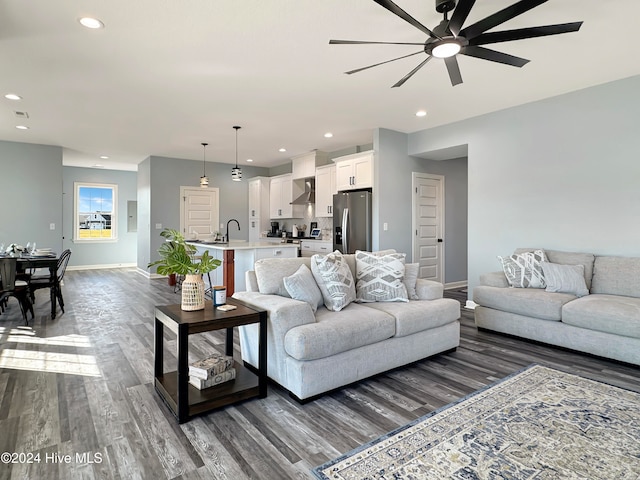 living room with ceiling fan, dark hardwood / wood-style flooring, and sink