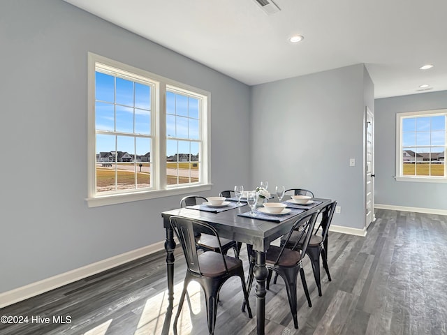 dining space with dark wood-type flooring