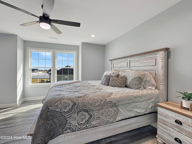 bedroom featuring hardwood / wood-style floors and ceiling fan