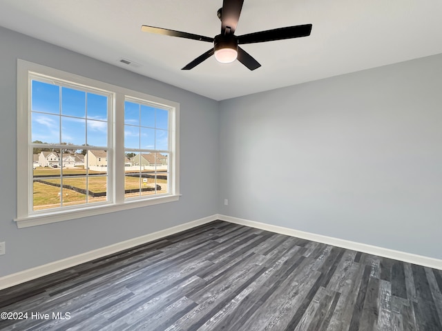 unfurnished room featuring ceiling fan and dark wood-type flooring