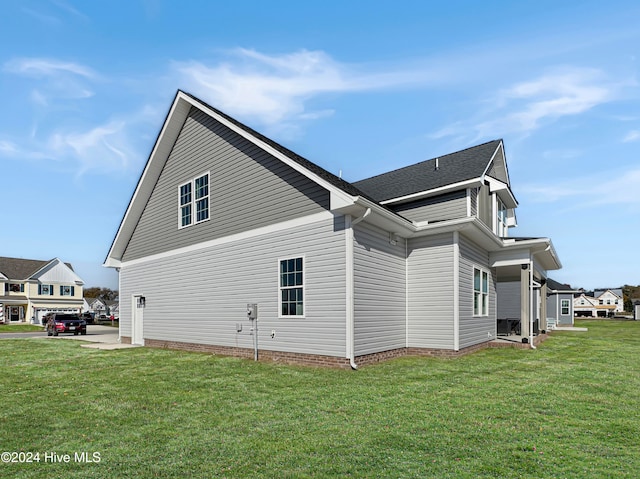 view of side of property with a yard