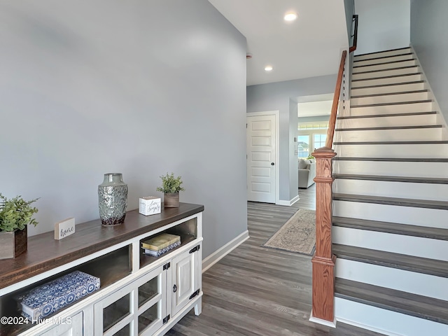 staircase with wood-type flooring