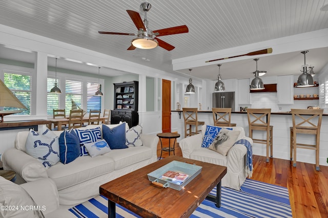 living room with ceiling fan and hardwood / wood-style floors