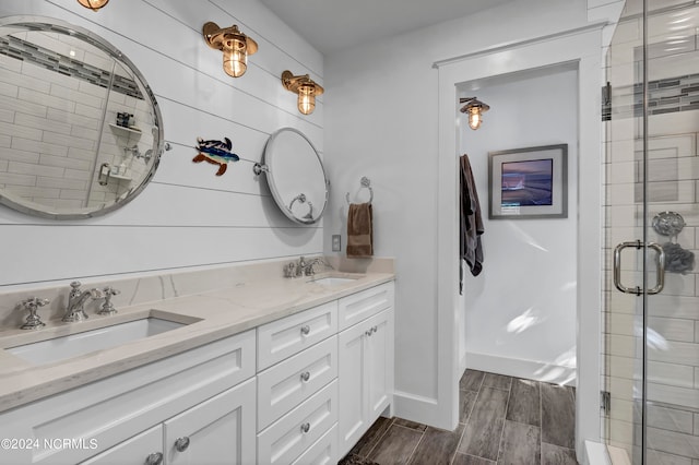 bathroom featuring vanity, a shower with shower door, and hardwood / wood-style flooring