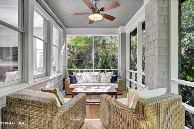 sunroom / solarium with ceiling fan, wooden ceiling, and a healthy amount of sunlight