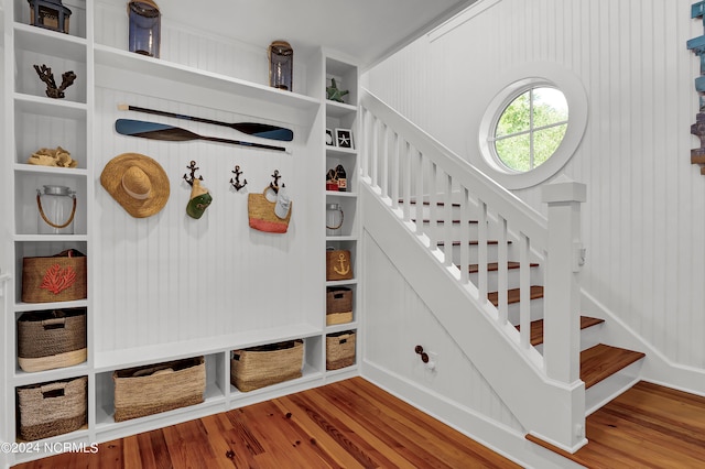 mudroom featuring wood walls and hardwood / wood-style floors