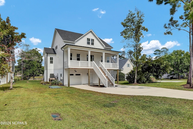 coastal home featuring a garage, a front lawn, and a porch