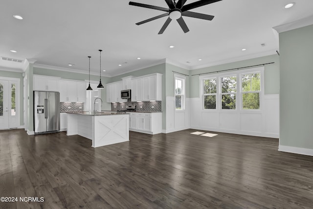 kitchen featuring stainless steel appliances, a center island with sink, and white cabinets