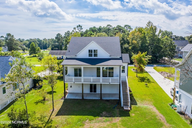 back of house with a yard and a patio area