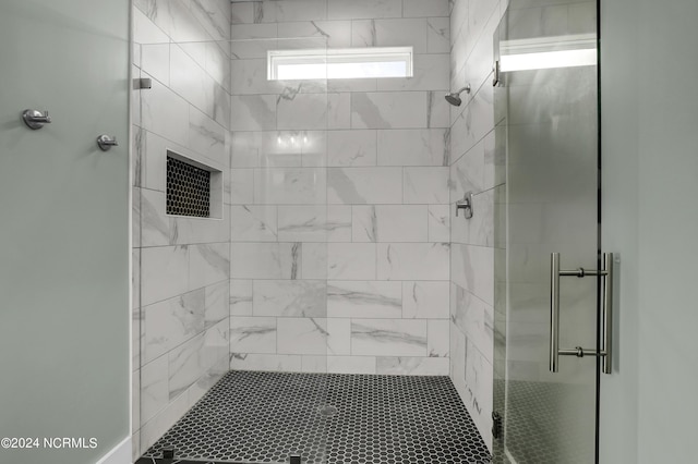 bathroom with a shower with door