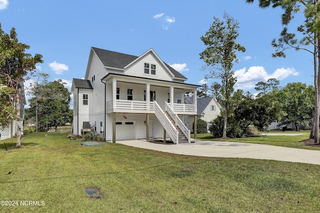 coastal inspired home featuring a porch, a garage, and a front lawn