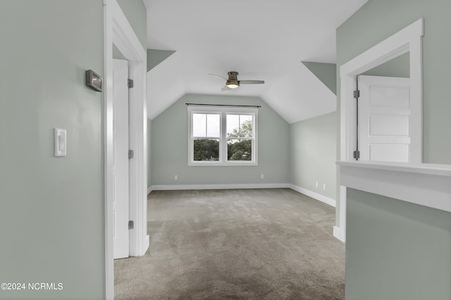 additional living space with lofted ceiling, light carpet, and ceiling fan