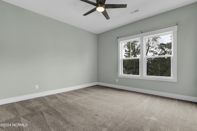 carpeted empty room featuring ceiling fan