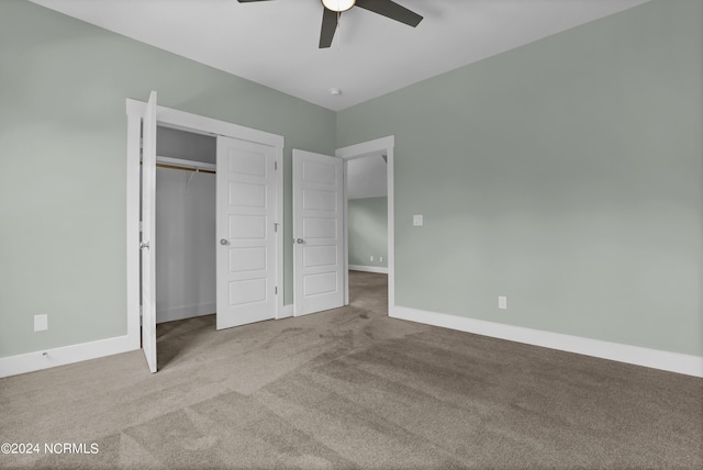 unfurnished bedroom featuring light carpet, a closet, and ceiling fan