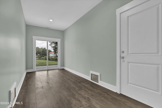 spare room featuring dark wood-type flooring