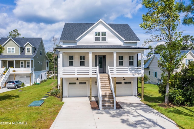 view of front of property featuring a garage, a front yard, and a porch