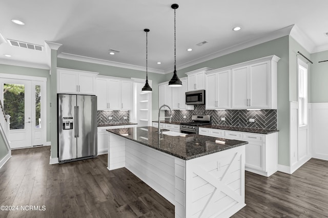 kitchen featuring sink, a center island with sink, appliances with stainless steel finishes, dark stone counters, and white cabinets