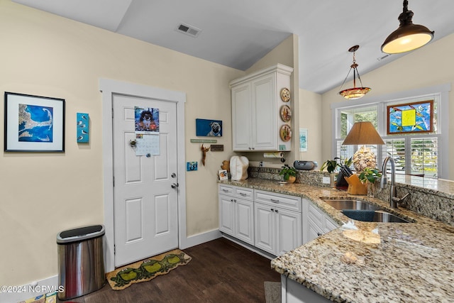 kitchen with dark hardwood / wood-style flooring, white cabinetry, lofted ceiling, and sink