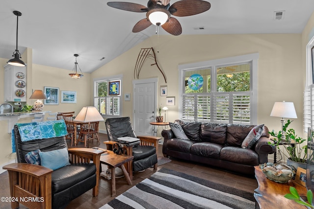 living room with dark hardwood / wood-style flooring, vaulted ceiling, ceiling fan, and a healthy amount of sunlight