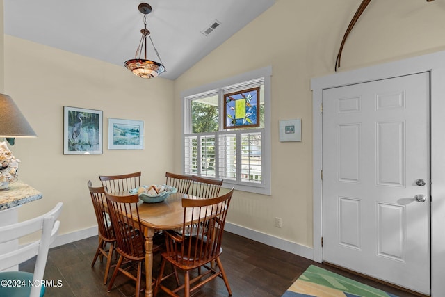 dining room with lofted ceiling and dark wood-type flooring