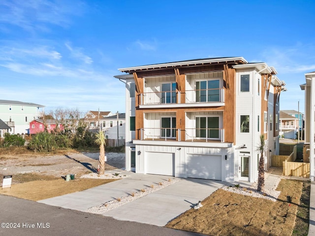 view of front of home featuring a balcony and a garage