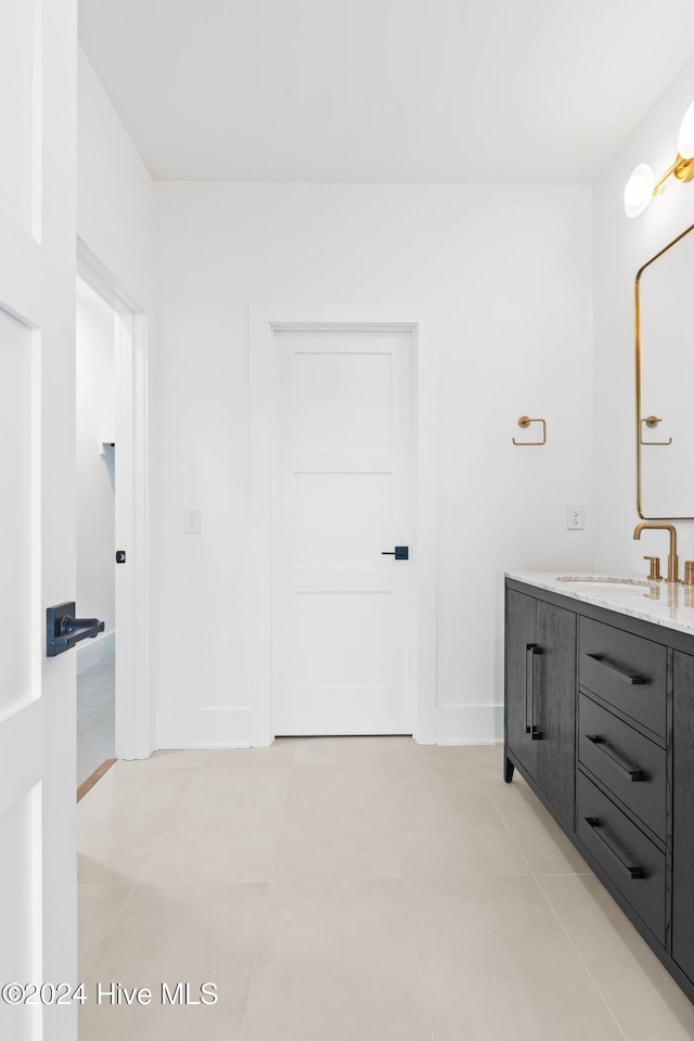 bathroom with tile patterned flooring and vanity