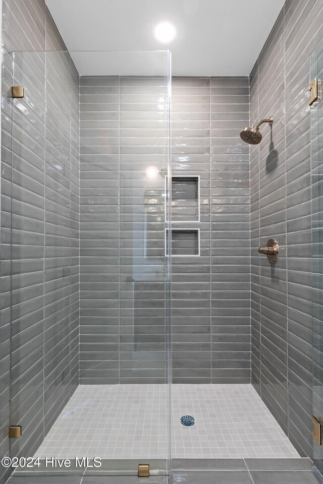 bathroom featuring a shower with door