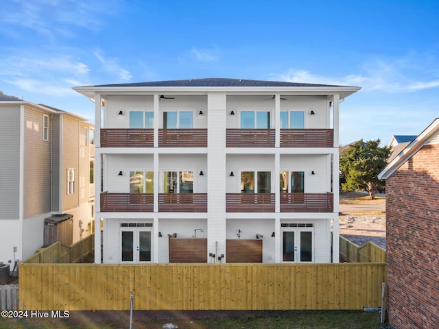 back of house featuring french doors and a balcony