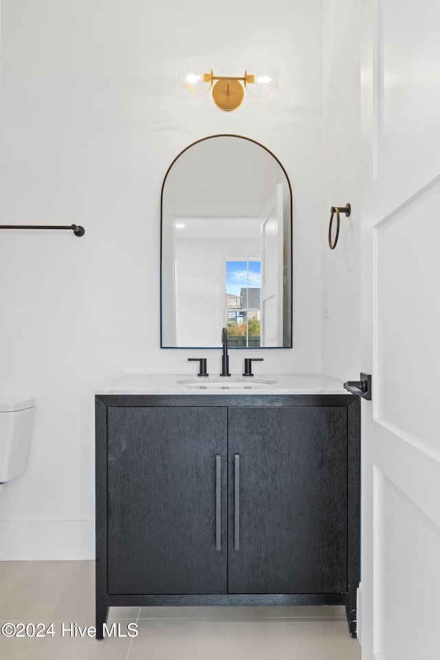 bathroom featuring vanity and toilet